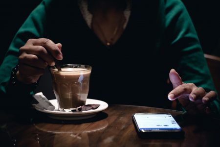 Person With Coffee in Cafe